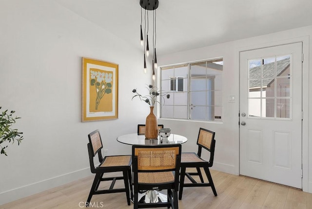 dining room with light wood-style flooring and baseboards