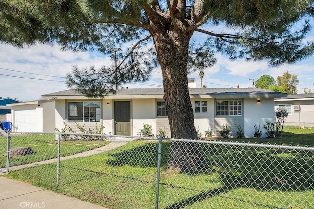 ranch-style house with fence, a front lawn, and stucco siding