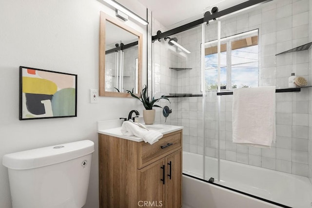 full bath featuring vanity, toilet, and bath / shower combo with glass door