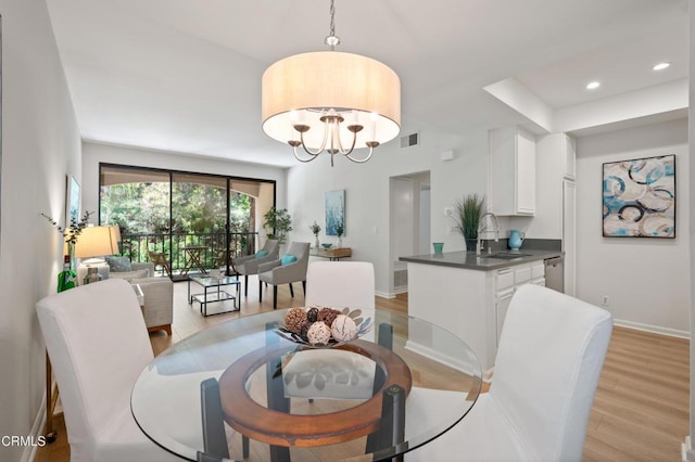 4200 Via Arbolada Unit 207, Los Angeles, CA 90042 - dining area with light wood finished floors, recessed lighting, and a chandelier