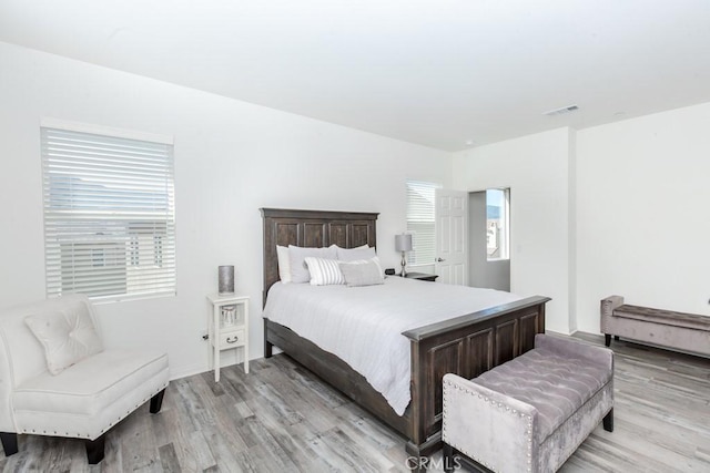 bedroom with visible vents and light wood-style flooring