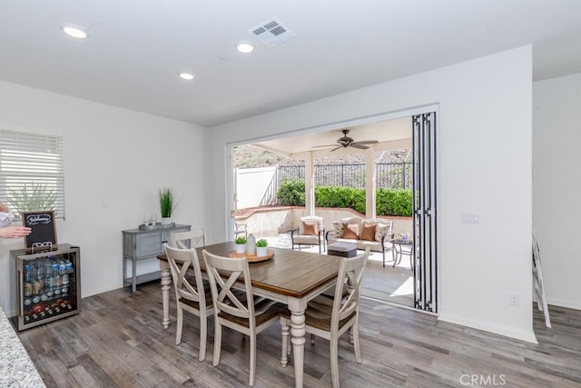 dining area featuring baseboards, visible vents, wood finished floors, and recessed lighting