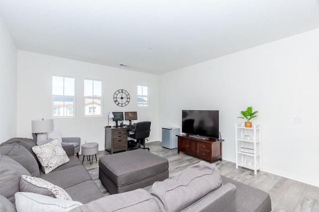 living area featuring light wood-type flooring and visible vents