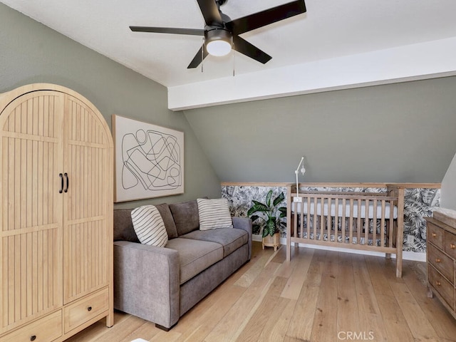 interior space with vaulted ceiling with beams, light wood finished floors, and a ceiling fan