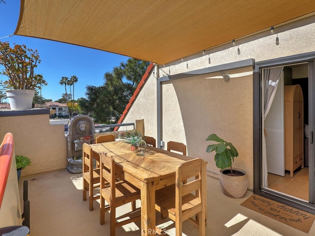 view of patio / terrace with outdoor dining space and a balcony