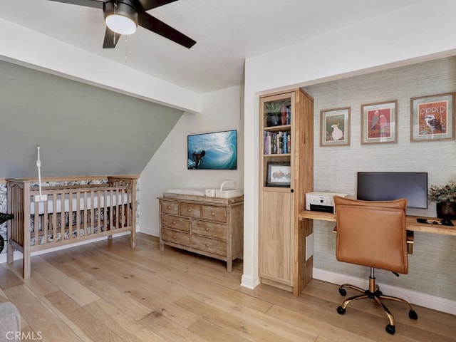 office space featuring vaulted ceiling with beams, light wood finished floors, ceiling fan, and baseboards