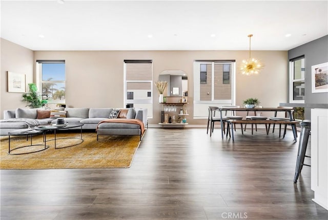 living room featuring dark wood finished floors, a notable chandelier, and recessed lighting