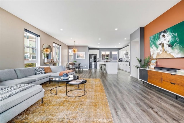 living room featuring plenty of natural light, wood finished floors, and recessed lighting