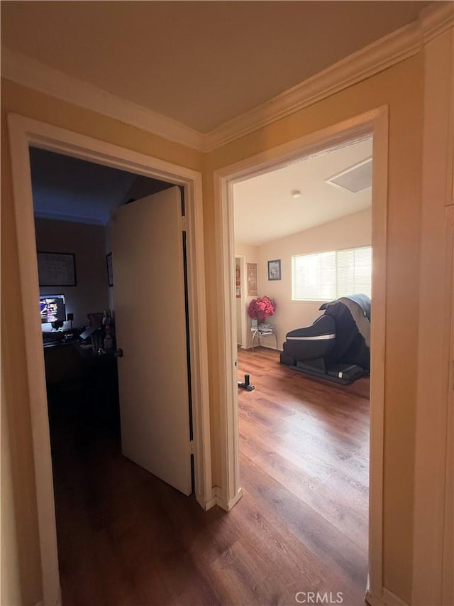 corridor with crown molding and wood finished floors