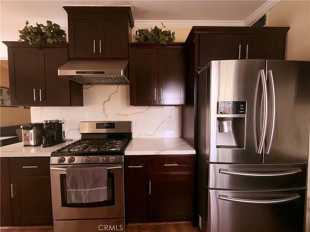 kitchen with light countertops, ornamental molding, appliances with stainless steel finishes, wall chimney range hood, and decorative backsplash