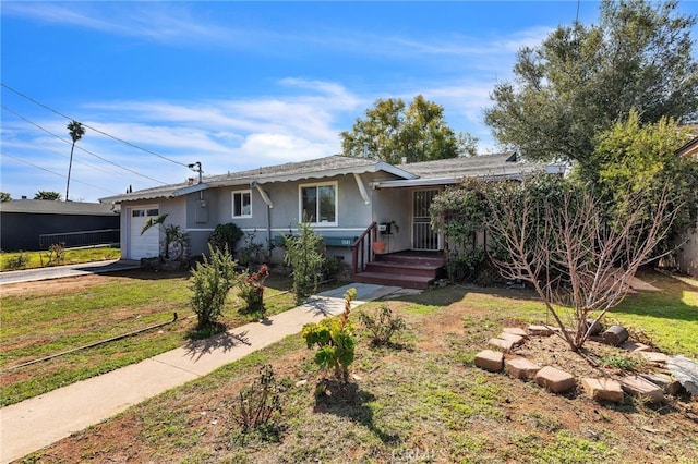 single story home featuring a garage, a front lawn, and stucco siding