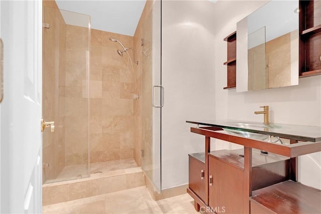 bathroom featuring a sink and a shower stall