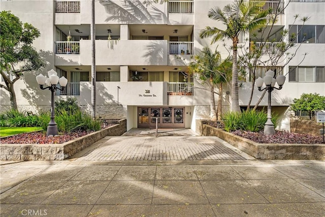 view of property with an attached garage and decorative driveway