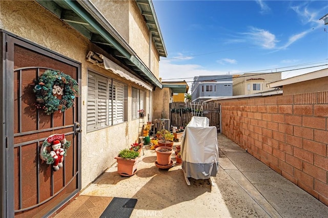 view of home's exterior with fence and stucco siding