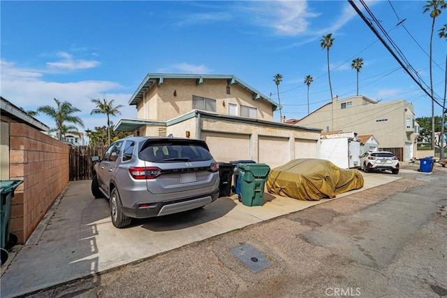 view of property exterior with fence and stucco siding