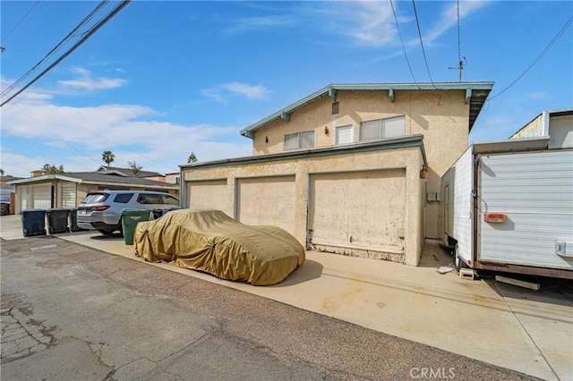 garage featuring concrete driveway