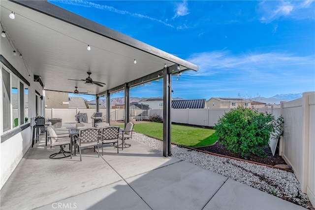 view of patio / terrace with a ceiling fan, outdoor dining area, and a fenced backyard