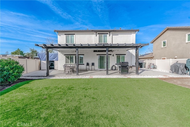 back of house featuring a patio area, a fenced backyard, a ceiling fan, and a yard