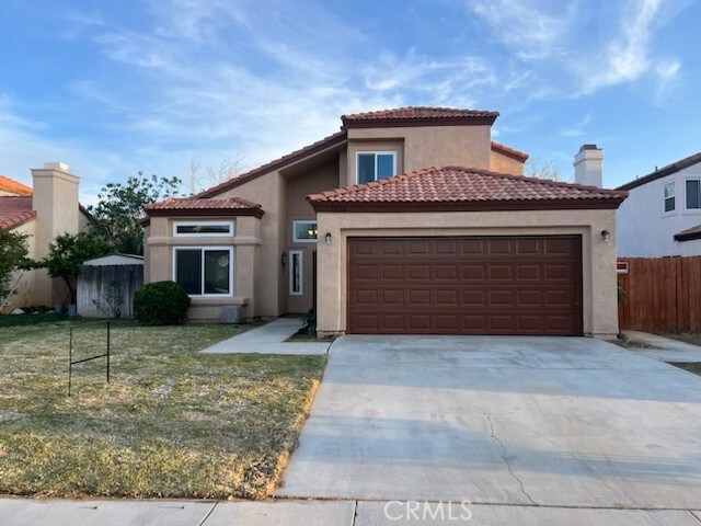 1726 Sierra View Ave, Lancaster, CA 93535 - mediterranean / spanish home featuring fence, stucco siding, a garage, and concrete driveway