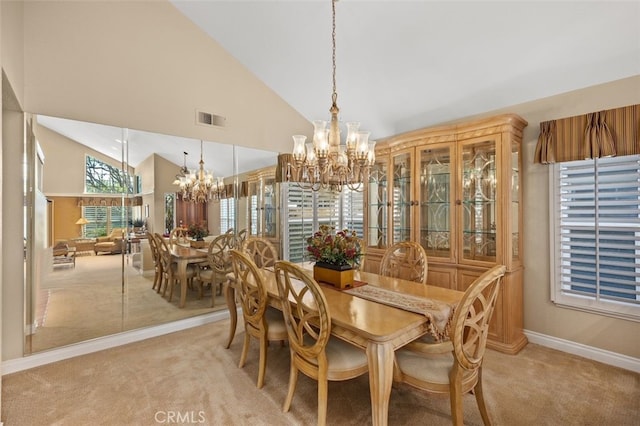 dining room with visible vents, an inviting chandelier, light carpet, high vaulted ceiling, and baseboards