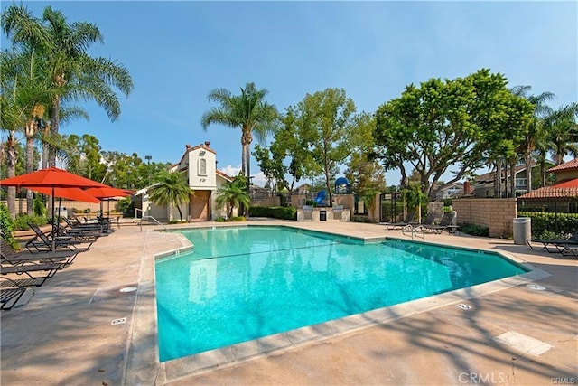 pool featuring a patio and fence