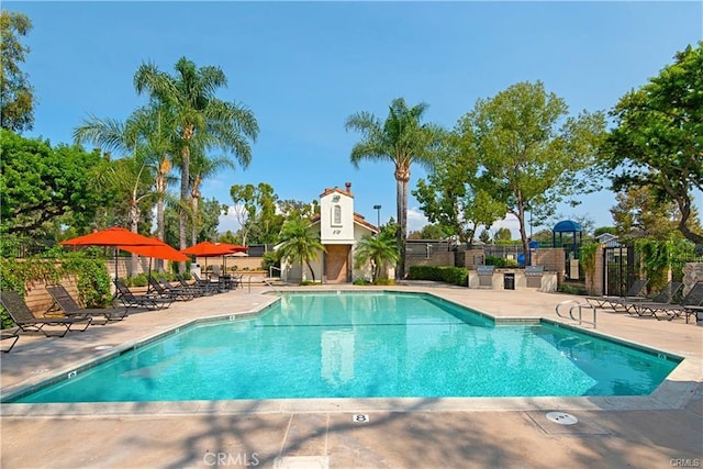 pool featuring a patio and fence