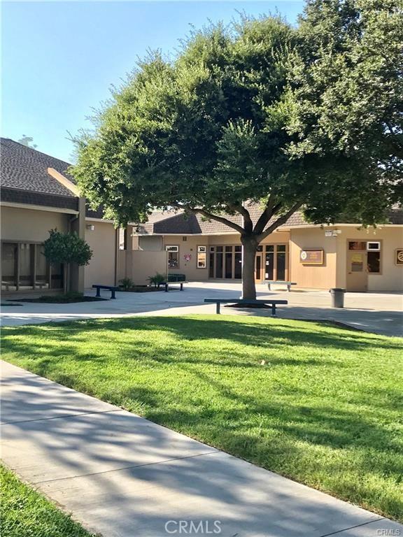 view of property's community with a lawn