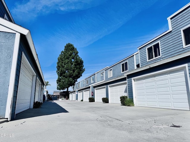 view of street with a residential view and community garages