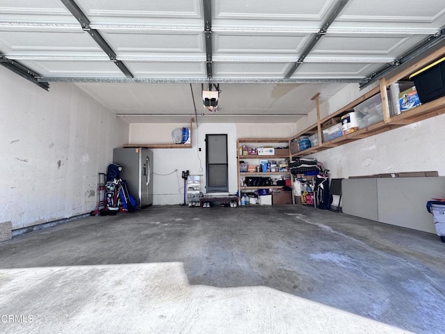 garage featuring stainless steel fridge with ice dispenser