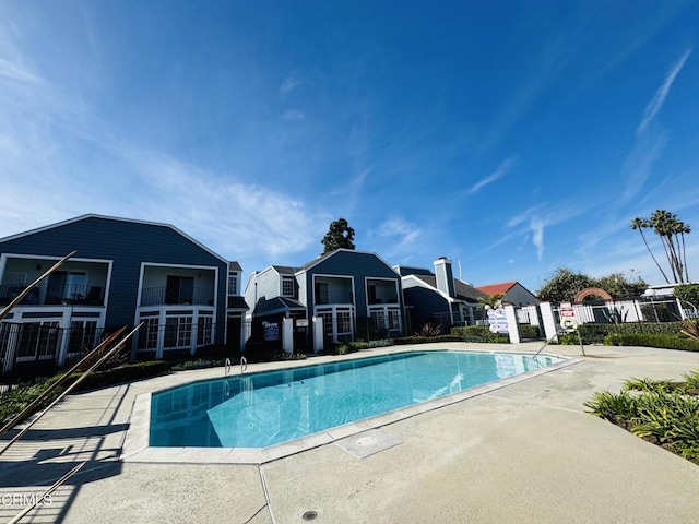 pool featuring a residential view and fence