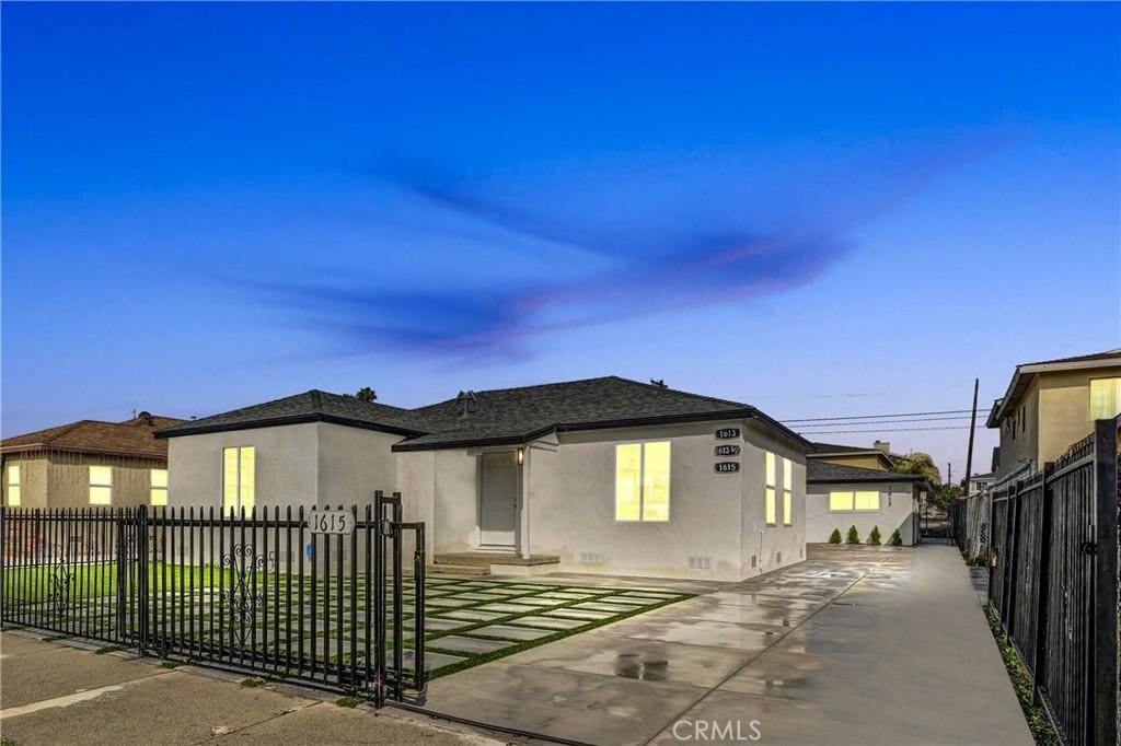 view of front of property featuring a fenced front yard and stucco siding