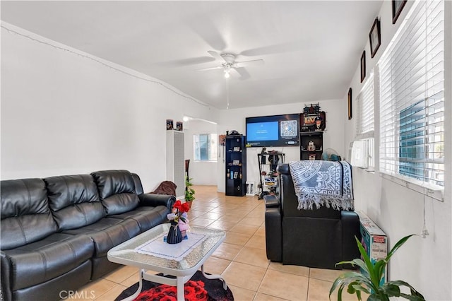 living area with ceiling fan and light tile patterned floors