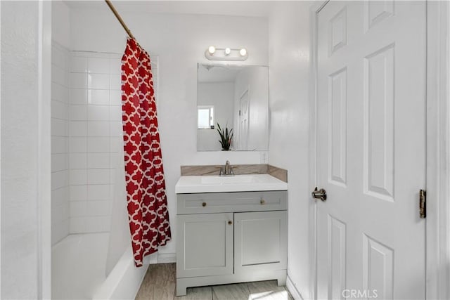 full bathroom with shower / bath combo, vanity, and wood finished floors