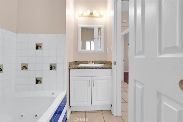 full bath featuring vanity, a whirlpool tub, and tile patterned floors