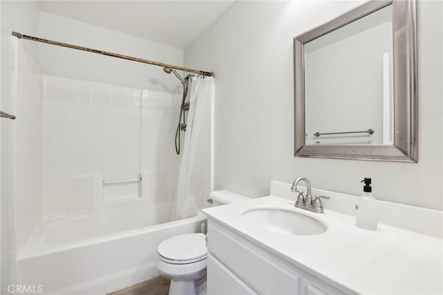 bathroom featuring toilet, shower / bath combo with shower curtain, wood finished floors, and vanity