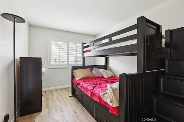 bedroom with baseboards and wood finished floors