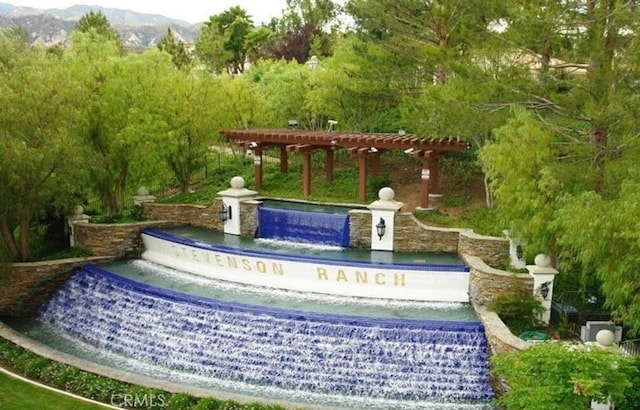 community / neighborhood sign featuring a mountain view