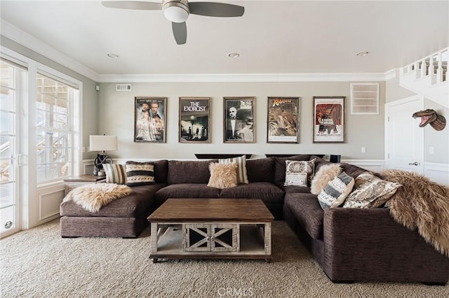 living area featuring visible vents, ornamental molding, and ceiling fan