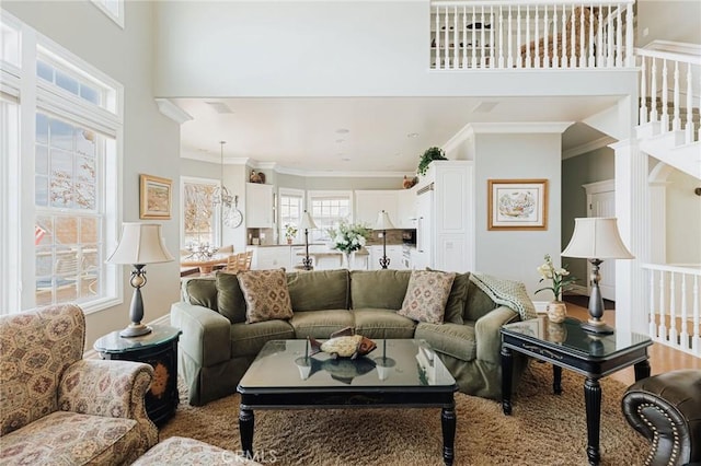 living room with a high ceiling and crown molding