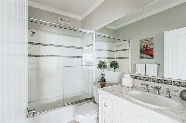 full bath featuring enclosed tub / shower combo, toilet, vanity, visible vents, and ornamental molding