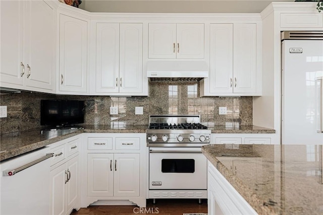 kitchen with premium appliances, stone counters, white cabinets, and exhaust hood