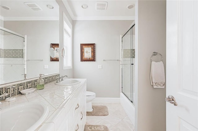 full bathroom with ornamental molding, a sink, toilet, and bath / shower combo with glass door