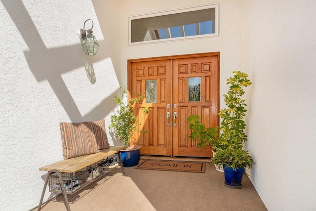 property entrance with stucco siding