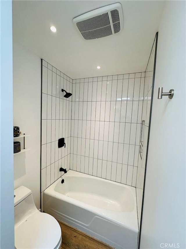 bathroom with recessed lighting, bathtub / shower combination, visible vents, and toilet