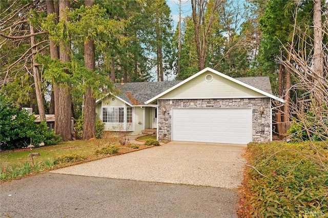 single story home with a garage, stone siding, and aphalt driveway