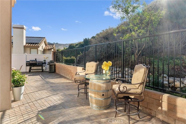 view of patio / terrace with a grill and fence