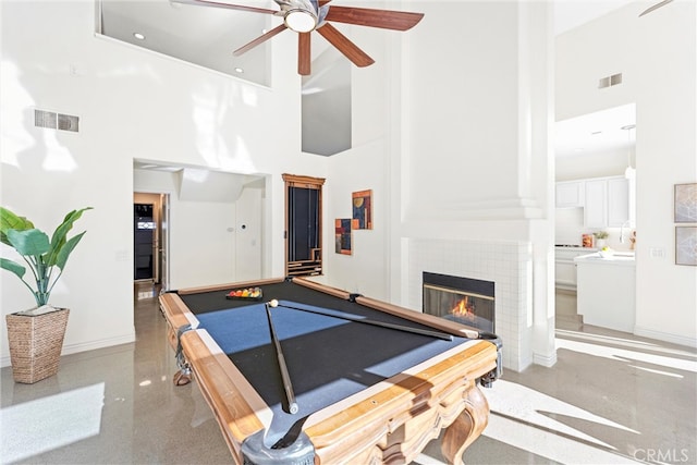 game room with a high ceiling, a fireplace, billiards, and visible vents