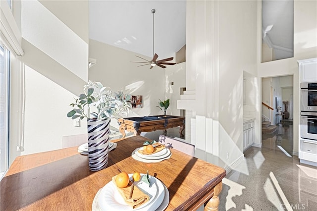 dining area featuring a high ceiling, stairway, a ceiling fan, and pool table