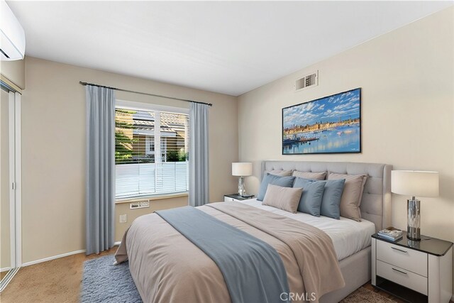 bedroom featuring carpet floors, visible vents, a wall unit AC, and baseboards