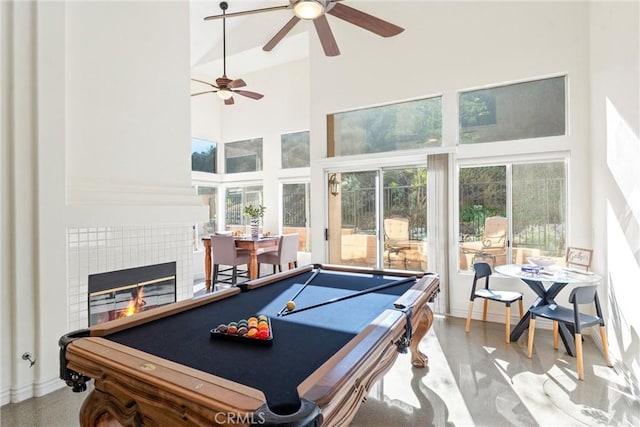 rec room featuring billiards, a high ceiling, plenty of natural light, and a fireplace